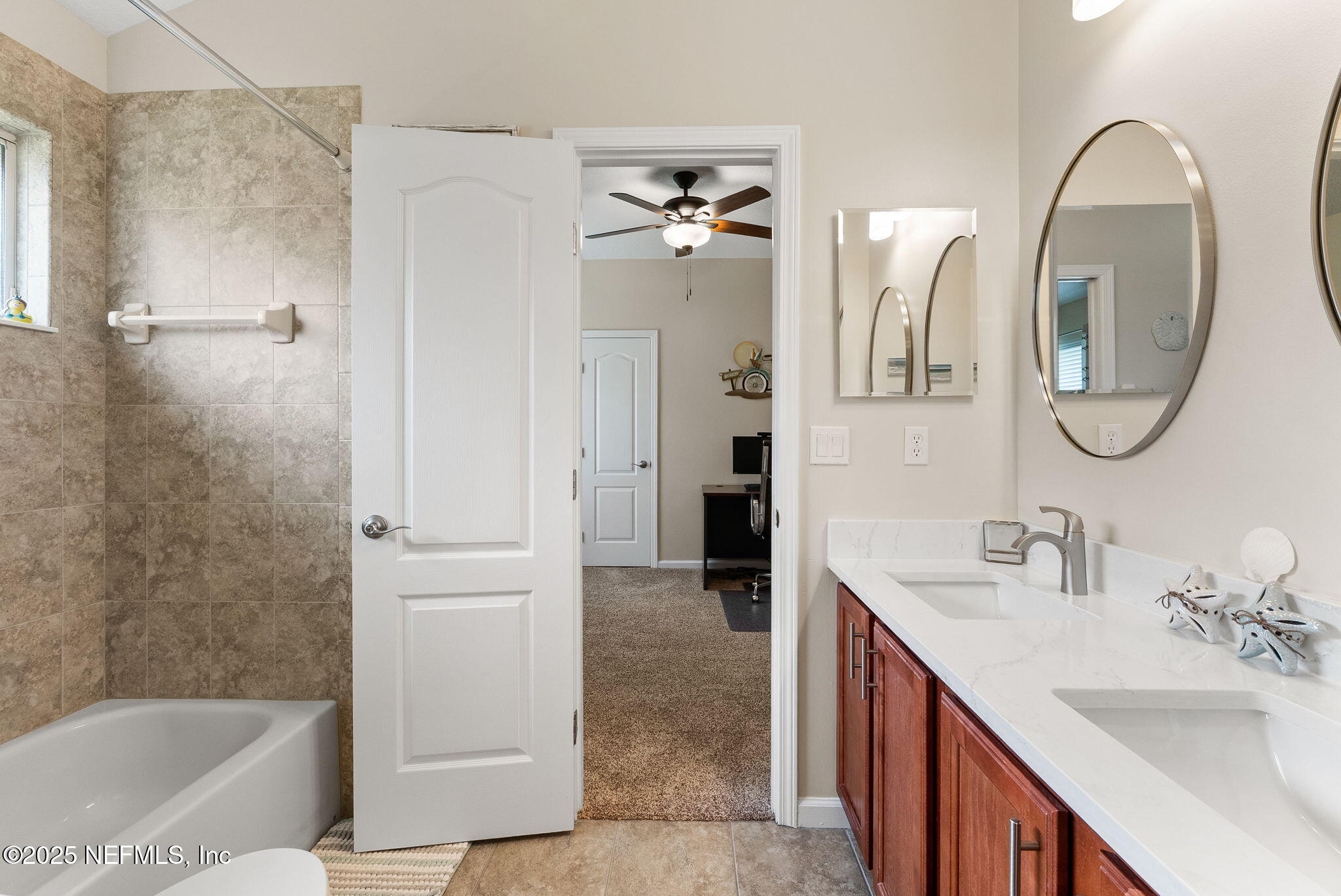 1428 Riva Del Garda Way St. Augustine, FL 32092 - Photo 32 of 44 a bathroom with a double vanity sink a mirror a bathtub and shower