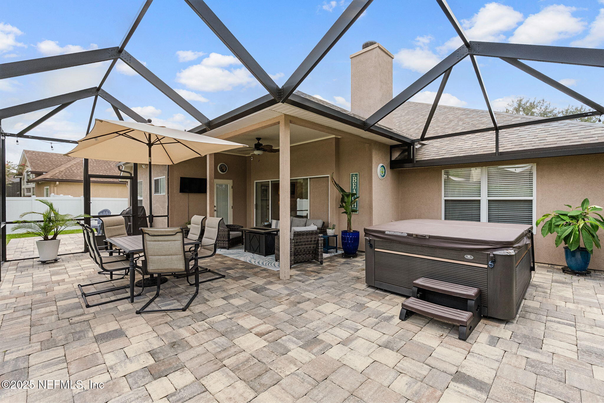 1428 Riva Del Garda Way St. Augustine, FL 32092 - Photo 36 of 44 a view of a patio with table and chairs under an umbrella