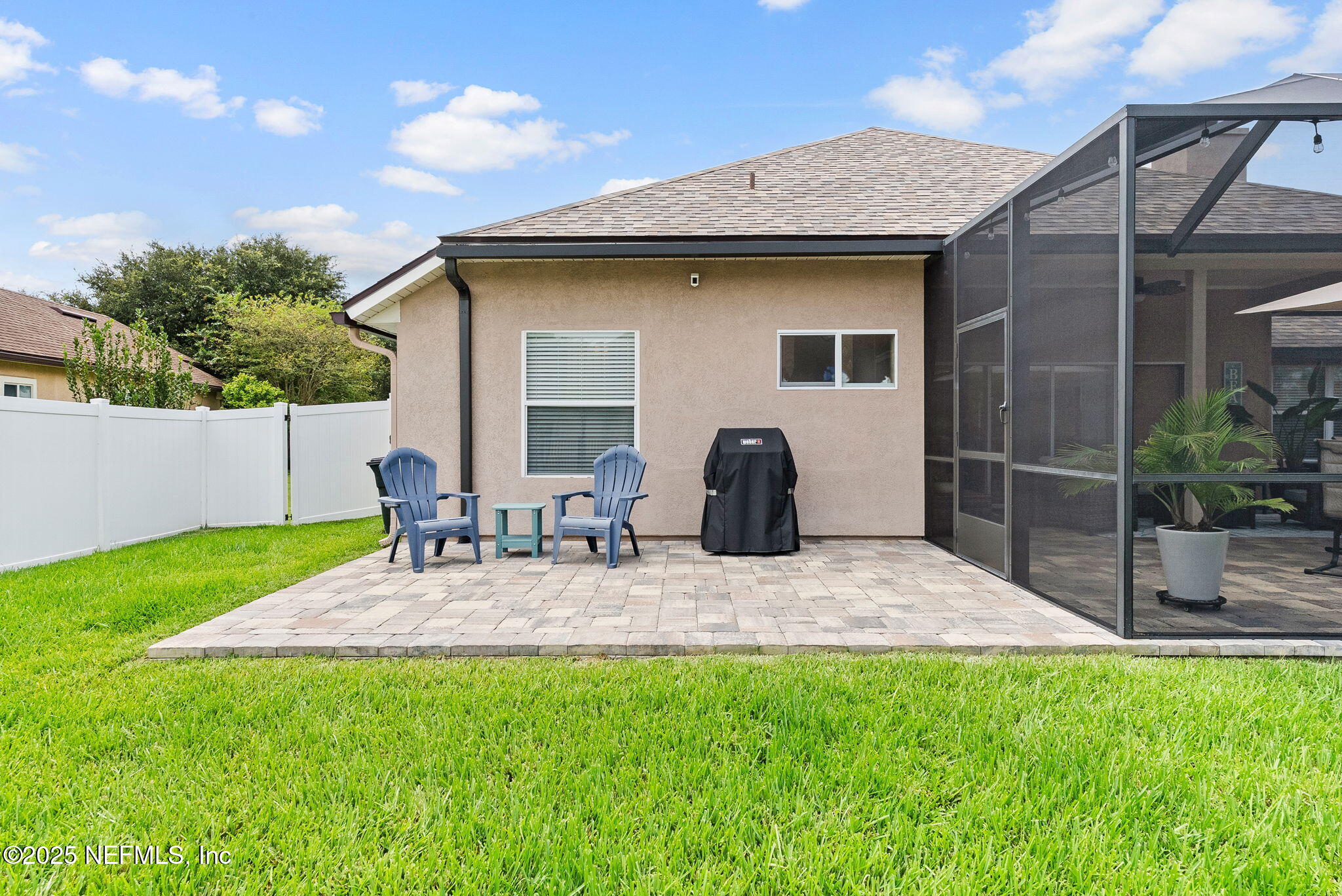 1428 Riva Del Garda Way St. Augustine, FL 32092 - Photo 38 of 44 a view of backyard of house with outdoor seating and trampoline
