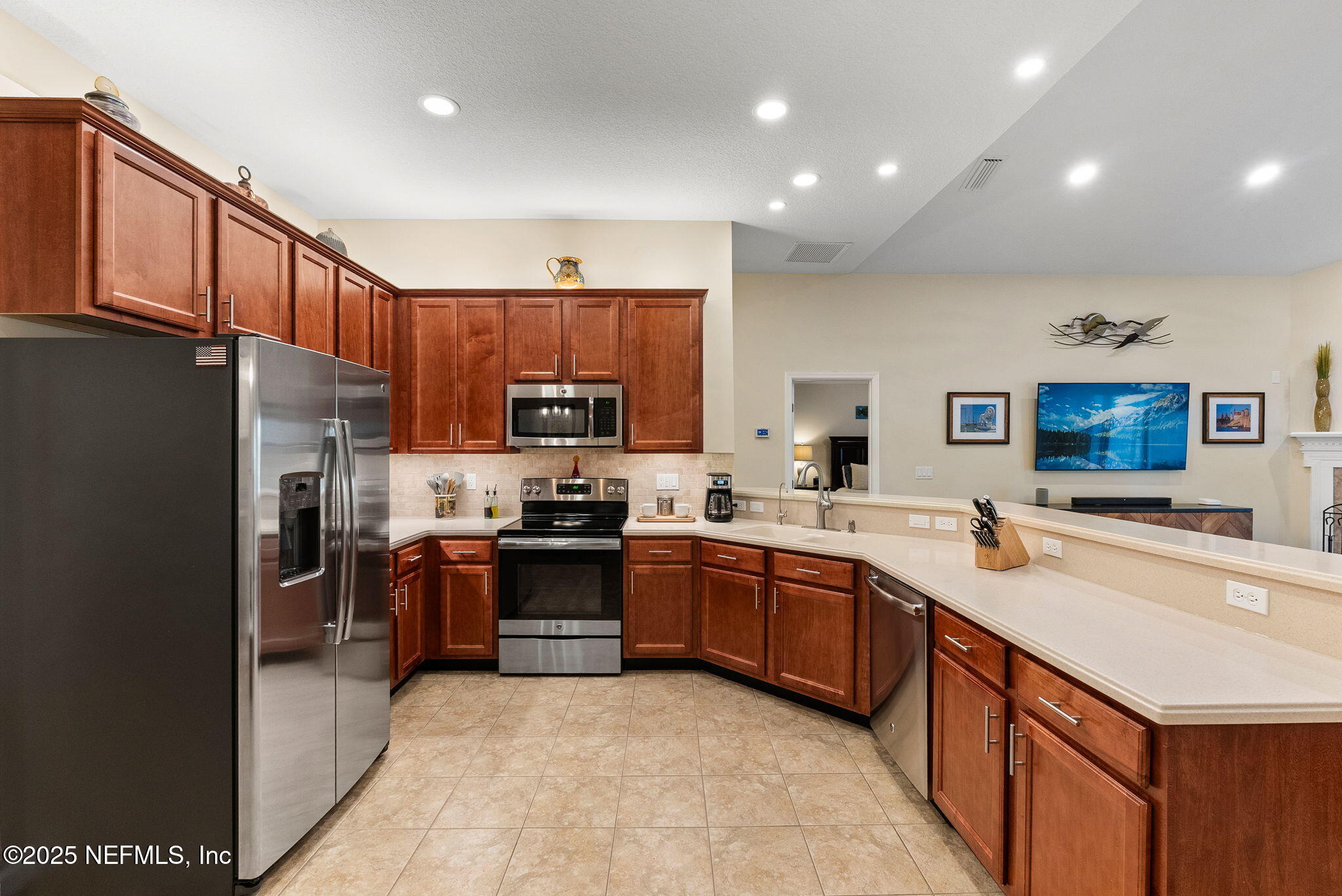 1428 Riva Del Garda Way St. Augustine, FL 32092 - Photo 10 of 44 a large kitchen with stainless steel appliances and a refrigerator
