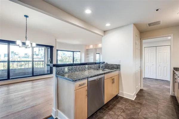 a kitchen with granite countertop a stove and a wooden floors