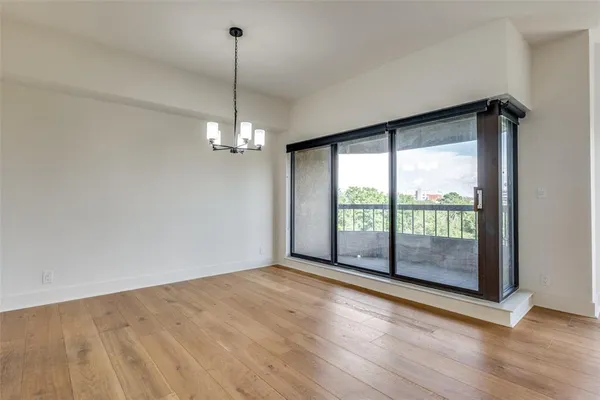a view of a room with window wooden floor and chandelier