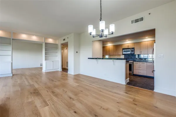 a view of a kitchen with a sink and stainless steel appliances