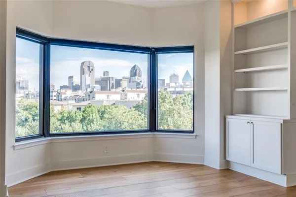 a view of a room with wooden floor and a window