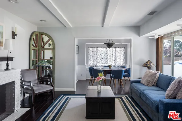 a living room with furniture a fireplace and a large window