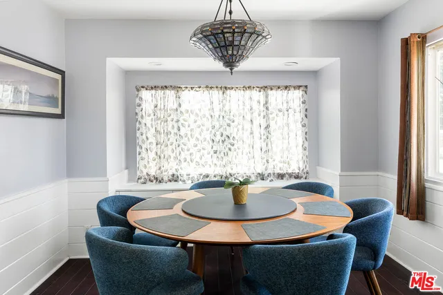 a dining room with furniture a window and a chandelier