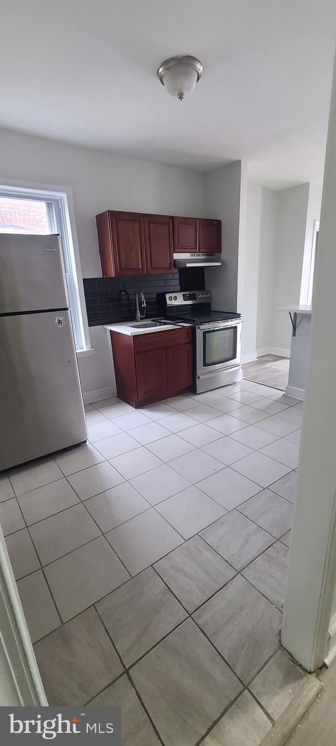 2026 Edgmont Avenue Chester, PA 19013 - Photo 6 of 11 a kitchen with stainless steel appliances a sink and cabinets