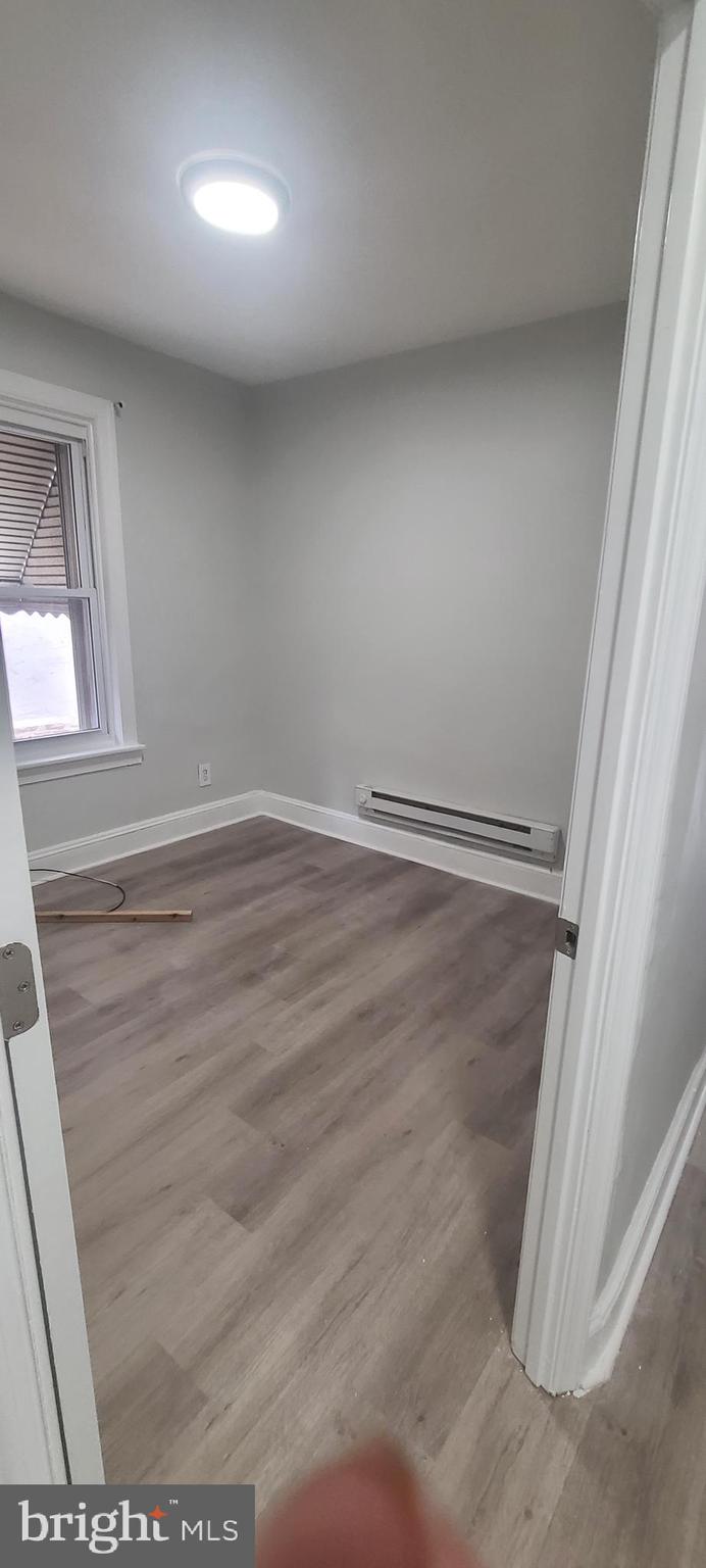 2026 Edgmont Avenue Chester, PA 19013 - Photo 7 of 11 en empty room with wooden floor and windows