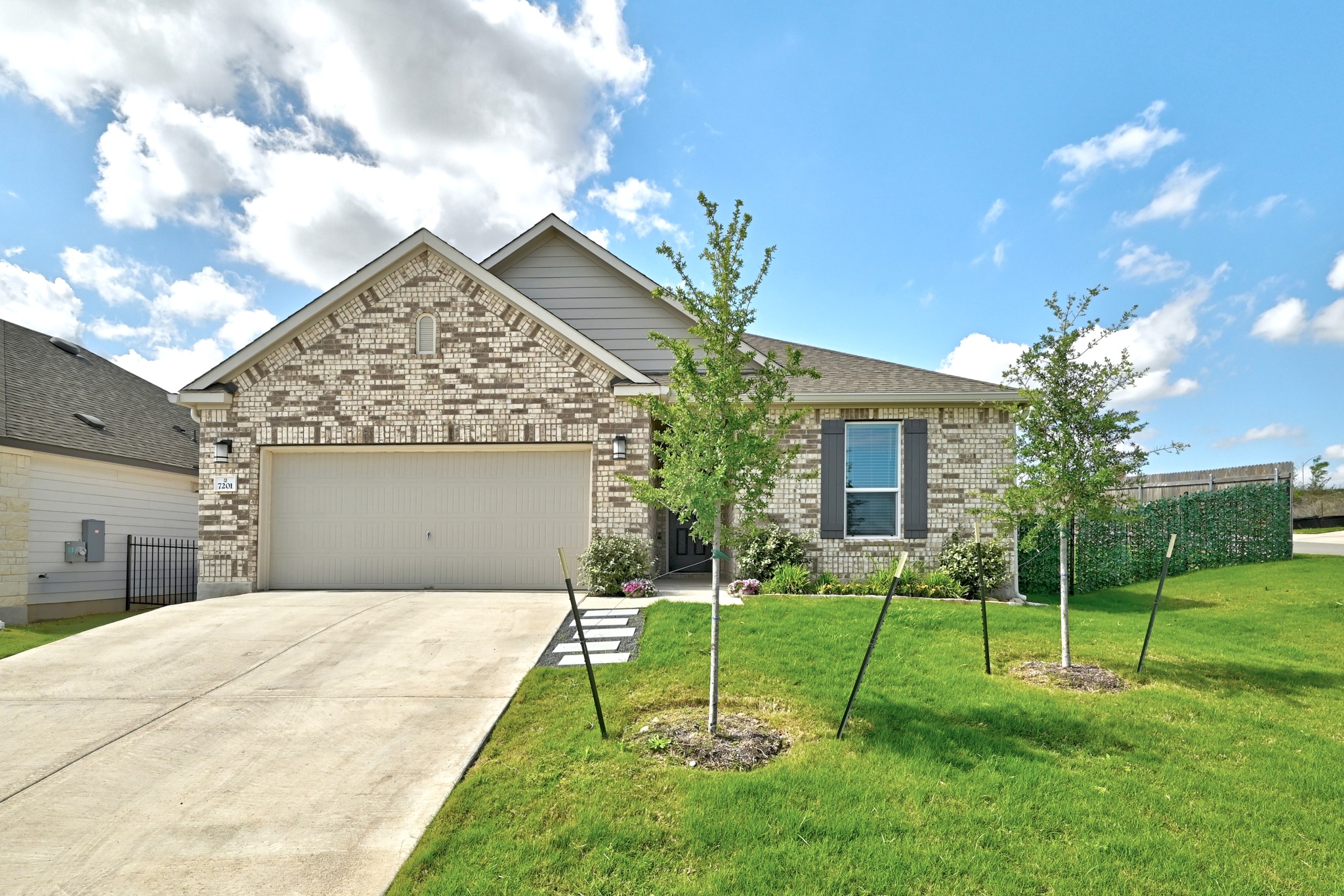 a view of a house with a yard and tree s