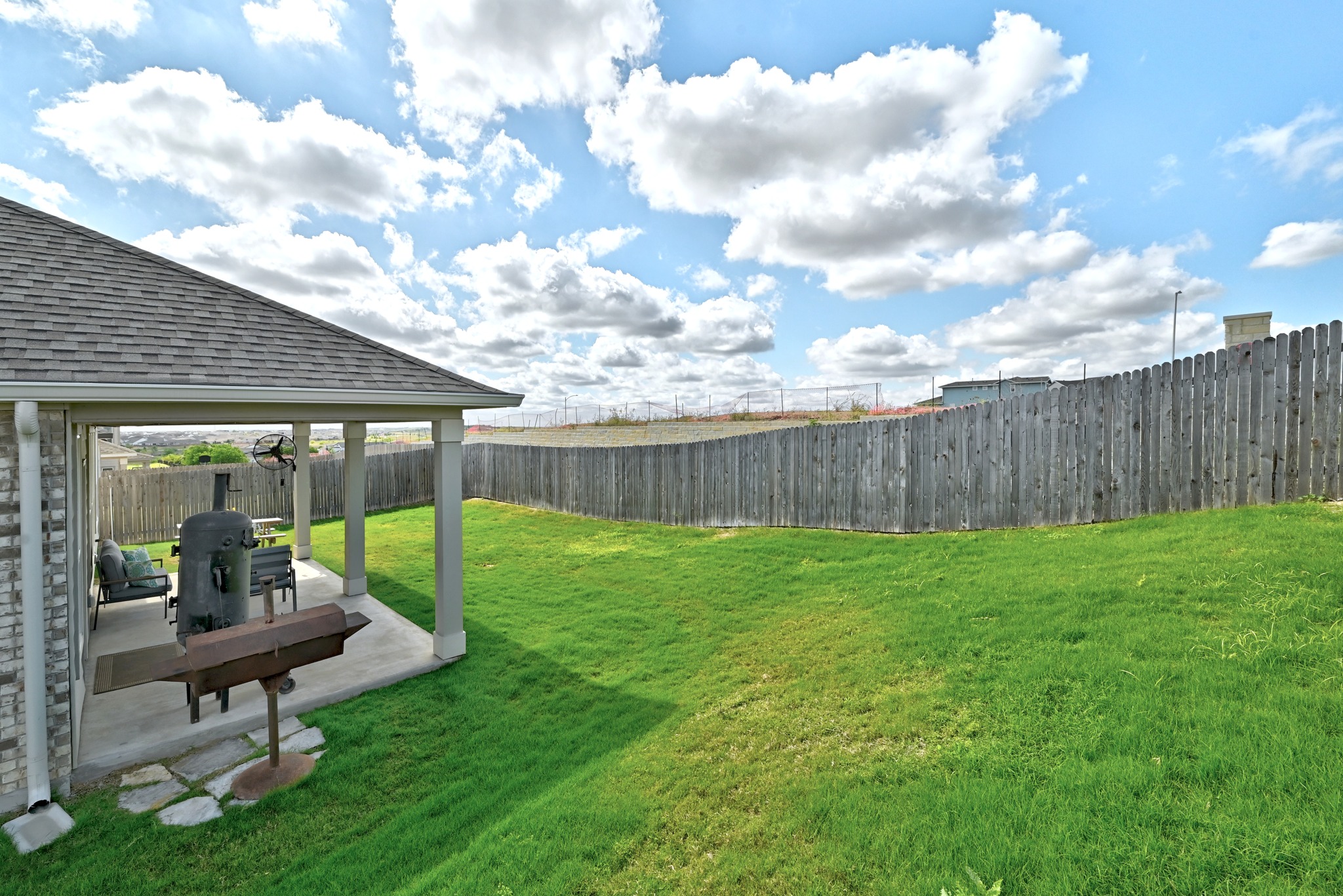 7201 Calliope Crossing Austin, TX 78744 - Photo 21 of 22 a view of a house with backyard sitting area and garden
