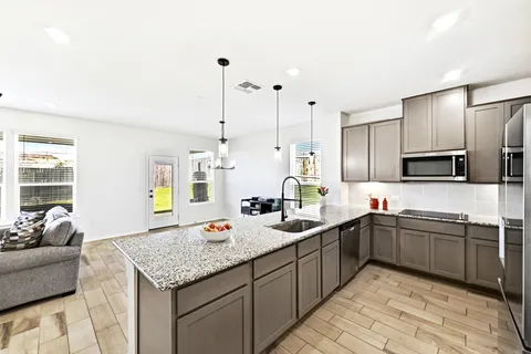 a kitchen with stainless steel appliances a refrigerator sink and microwave