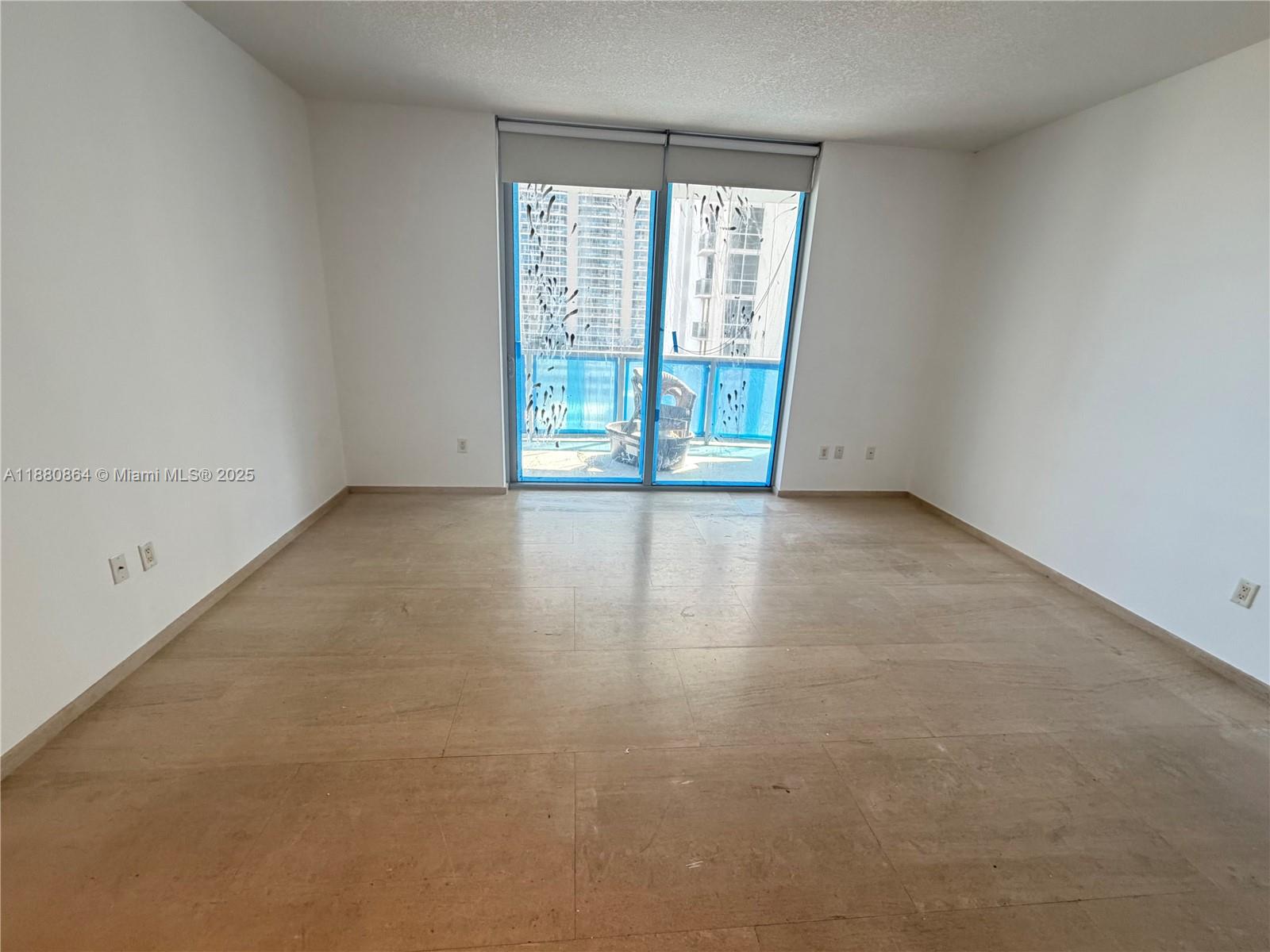 1050 Brickell Avenue, Unit 2206 Miami, FL 33131 - Photo 2 of 9 an empty room with windows