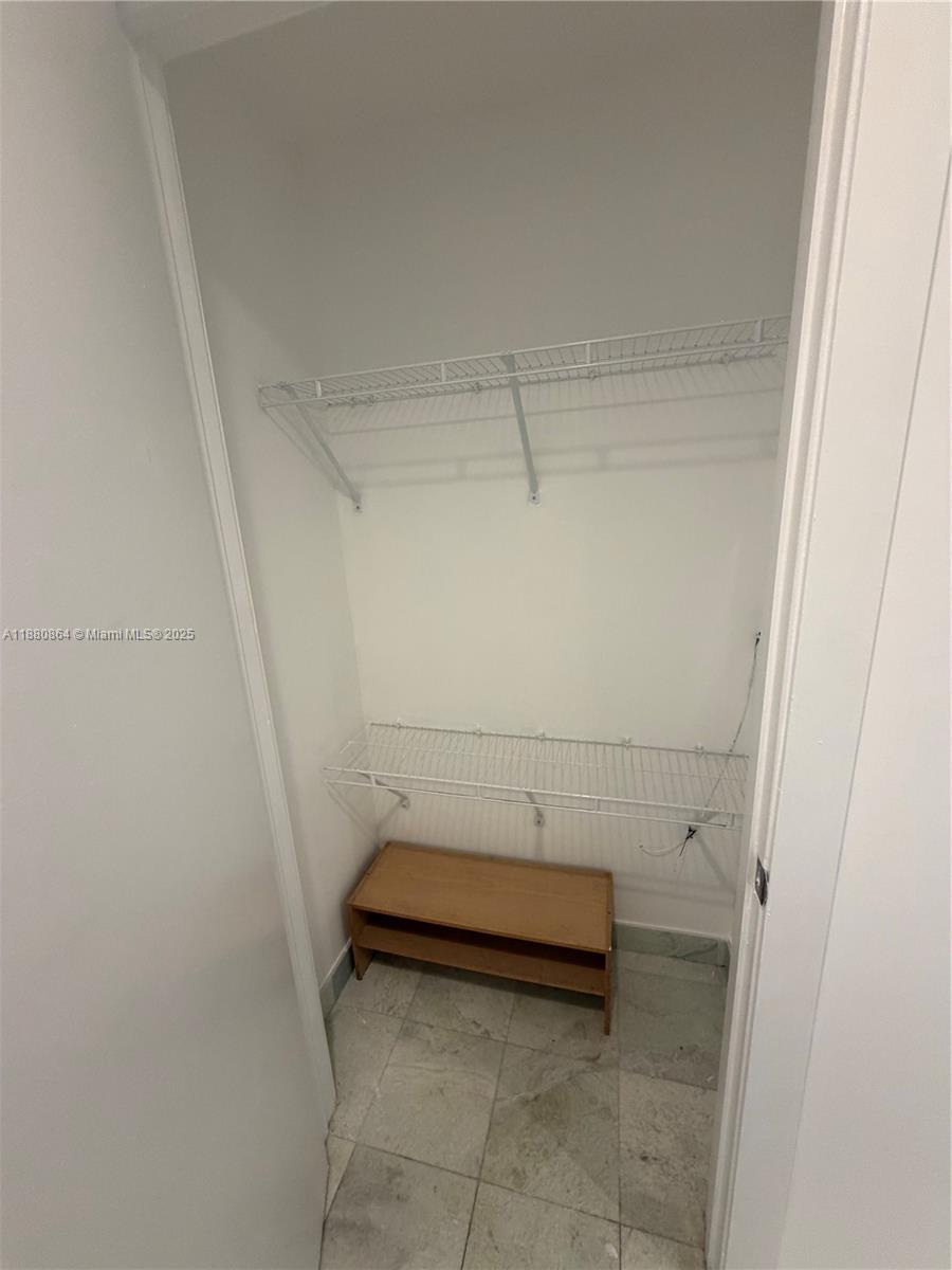 1050 Brickell Avenue, Unit 2206 Miami, FL 33131 - Photo 6 of 9 a view of a room with racks on the wall