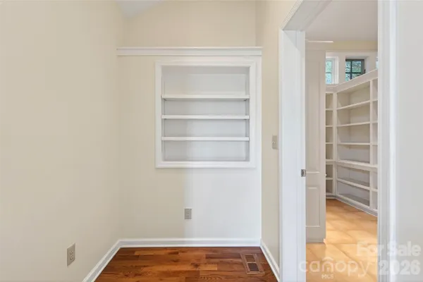 a view of an empty room with empty shelves