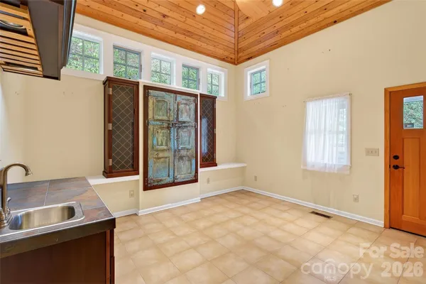 a view of a kitchen with stainless steel appliances granite countertop a stove and a refrigerator with cabinets