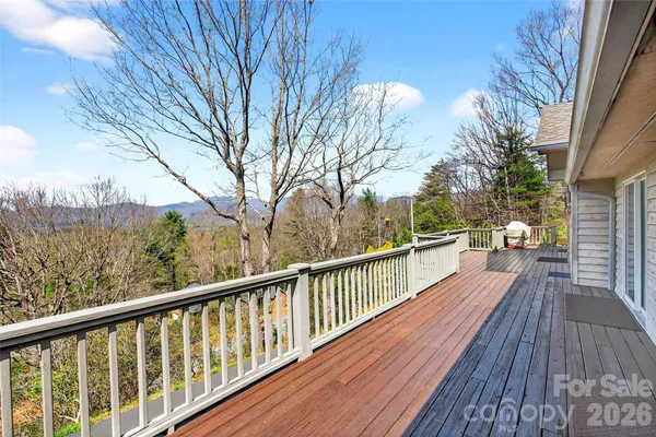 a view of balcony with wooden floor and fence