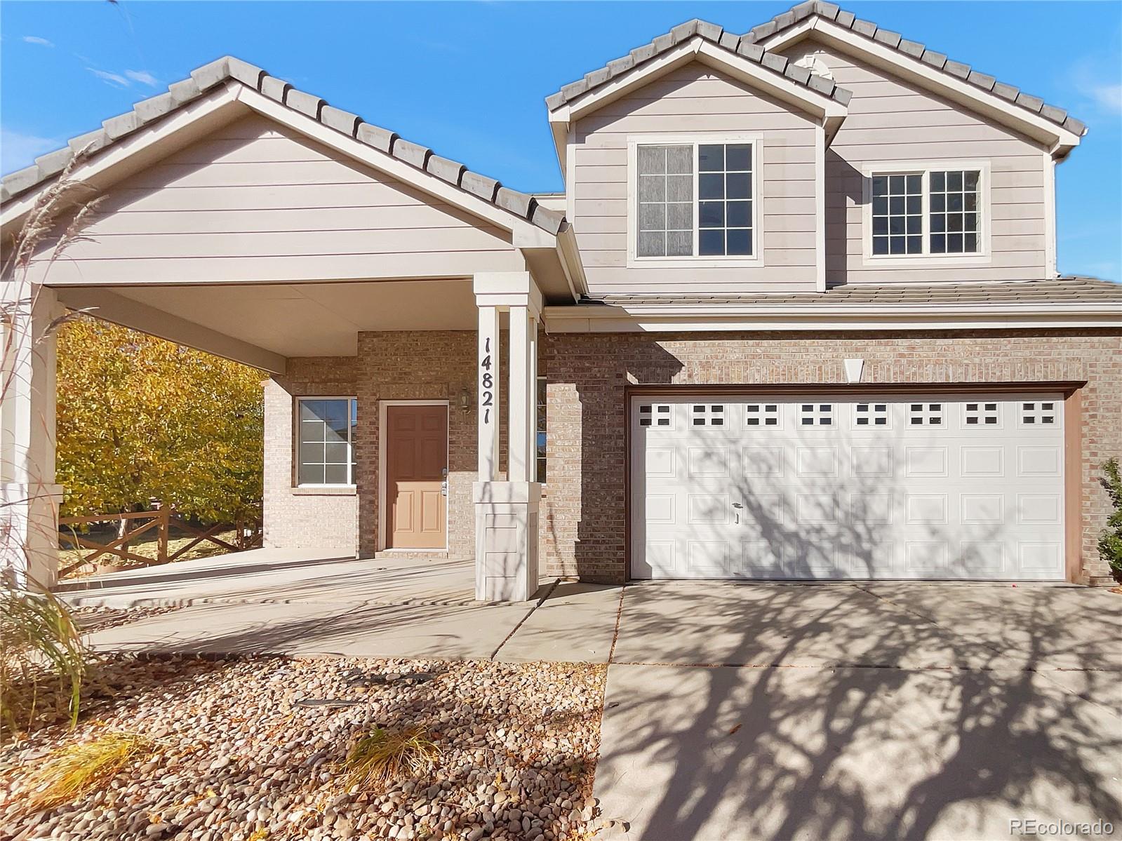 a view of a house with a yard and garage