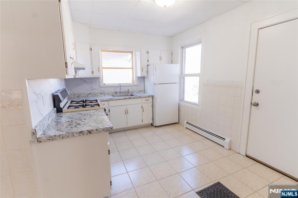 125 Clark Place, Unit 123 Elizabeth, NJ 07206 - Photo 10 of 16 a kitchen with granite countertop a sink cabinets and window