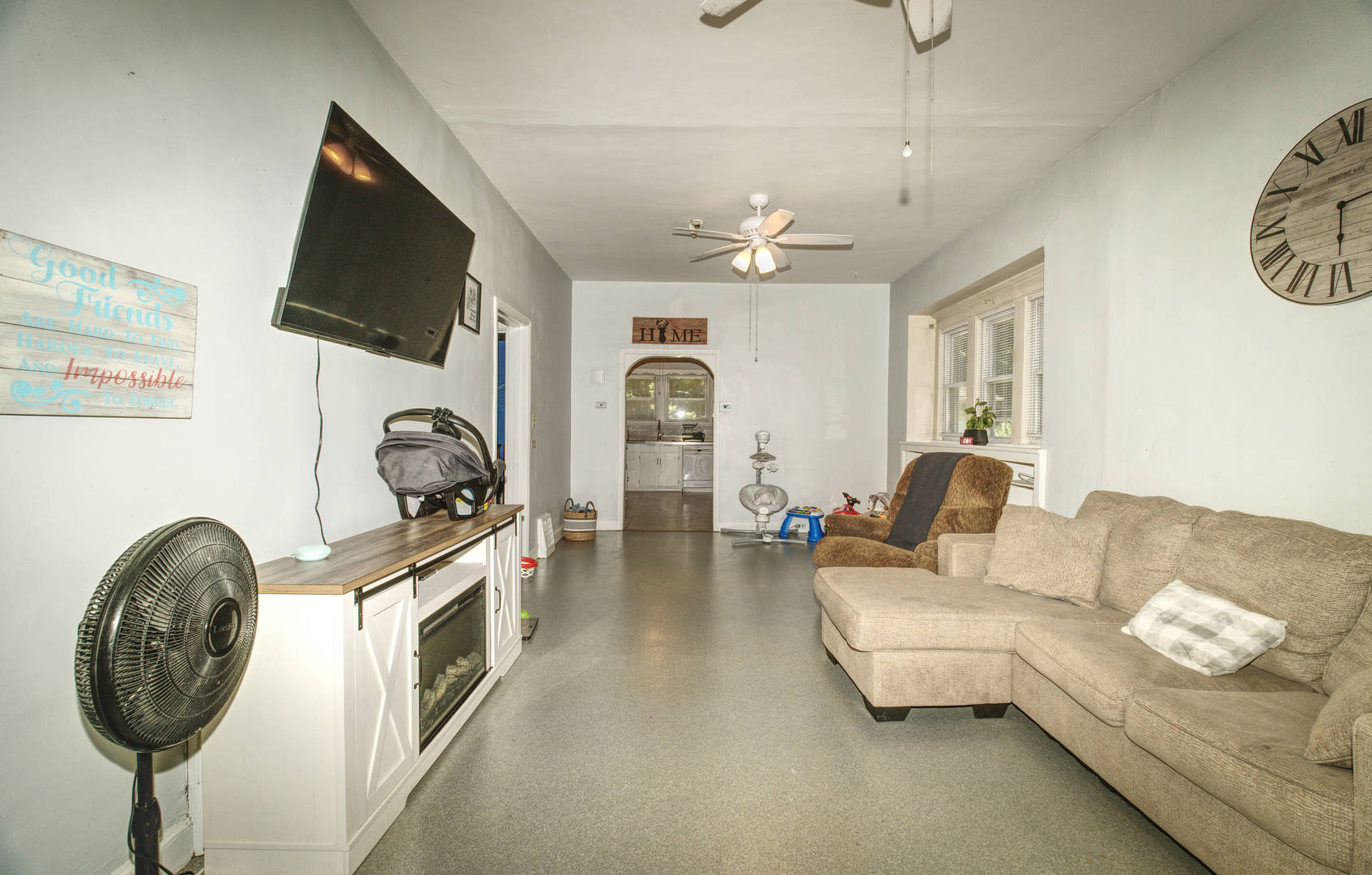 2108 Camanche Avenue Clinton, IA 52732 - Photo 7 of 22 a living room with furniture a flat screen tv and a fireplace