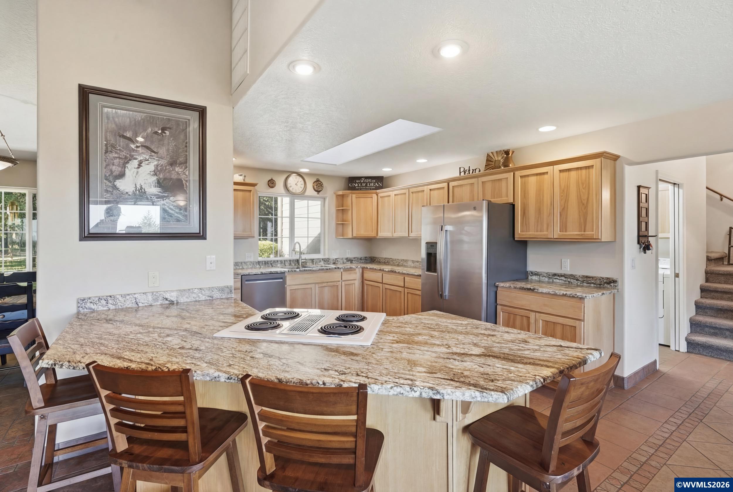 1110 Reuben Boise Road Dallas, OR 97338 - Photo 13 of 49 a kitchen with granite countertop kitchen island cabinets stainless steel appliances and a dining table