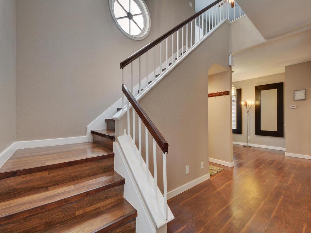 a view of staircase with wooden floor and white walls