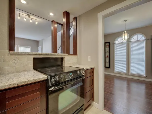 a kitchen with a stove and a wooden floors