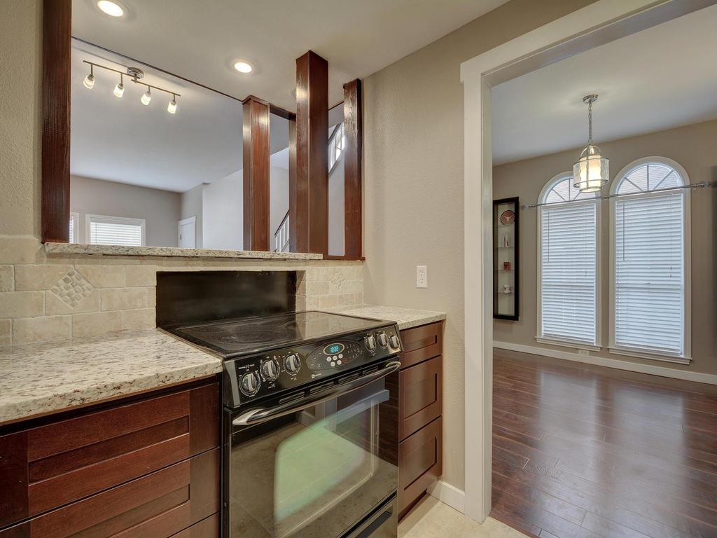 2529 Rio Grande Street, Unit 58 Austin, TX 78705 - Photo 12 of 23 a kitchen with a stove and a wooden floors