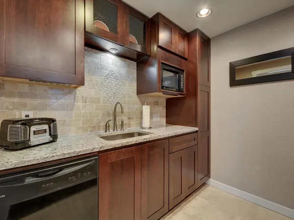 a kitchen with stainless steel appliances a sink a stove and a microwave