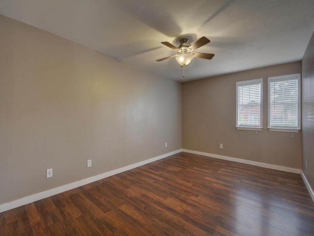 2529 Rio Grande Street, Unit 58 Austin, TX 78705 - Photo 20 of 23 a view of an empty room with wooden floor and a window