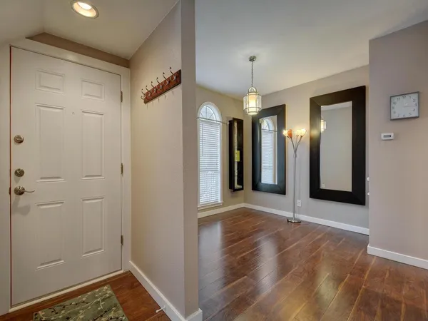 a view of a room with wooden floor and staircase