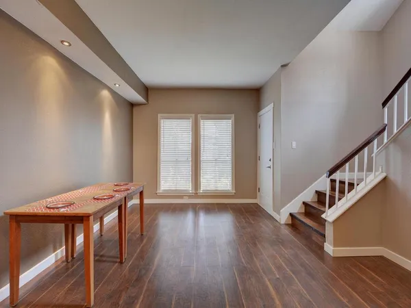 a view of a livingroom with wooden floor and stairs