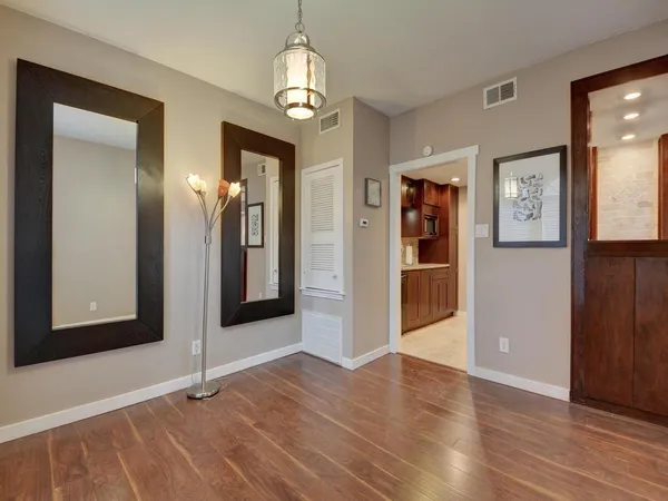 wooden floor in an empty room with a mirror