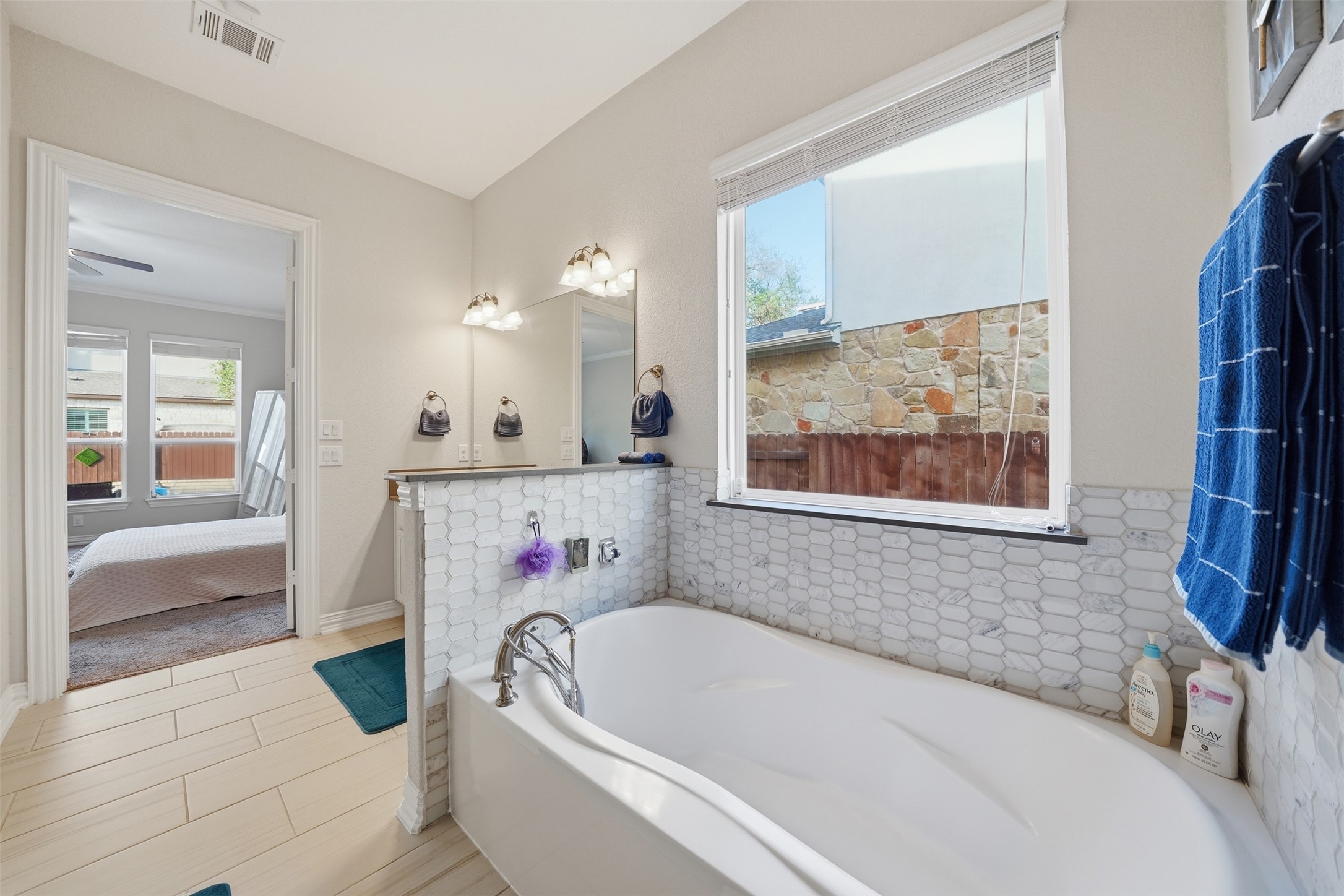 4301 Logan Ridge Drive Cedar Park, TX 78613 - Photo 19 of 38 Full bath featuring connected bathroom, plenty of natural light, and a garden tub