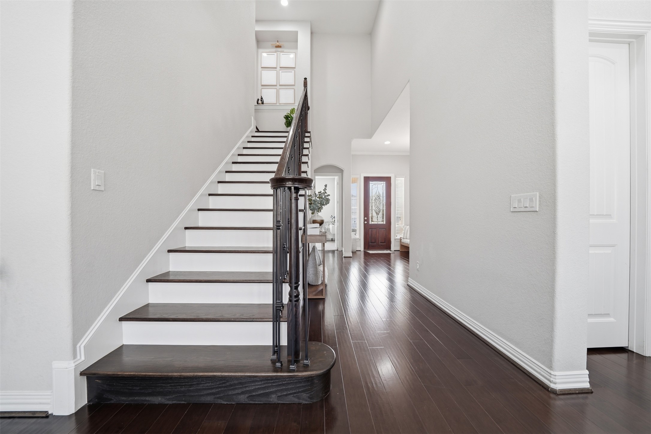 4301 Logan Ridge Drive Cedar Park, TX 78613 - Photo 23 of 38 Stairway featuring a high ceiling, hardwood / wood-style flooring, recessed lighting, and arched walkways