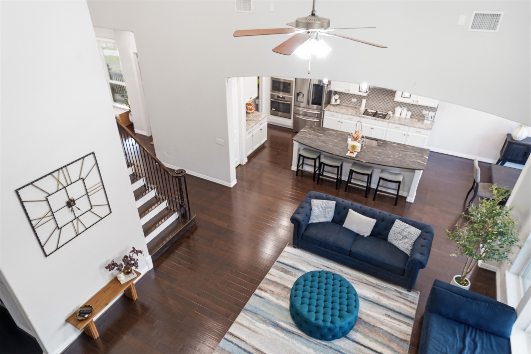 4301 Logan Ridge Drive Cedar Park, TX 78613 - Photo 25 of 38 Living room with a ceiling fan, dark wood finished floors, and a high ceiling