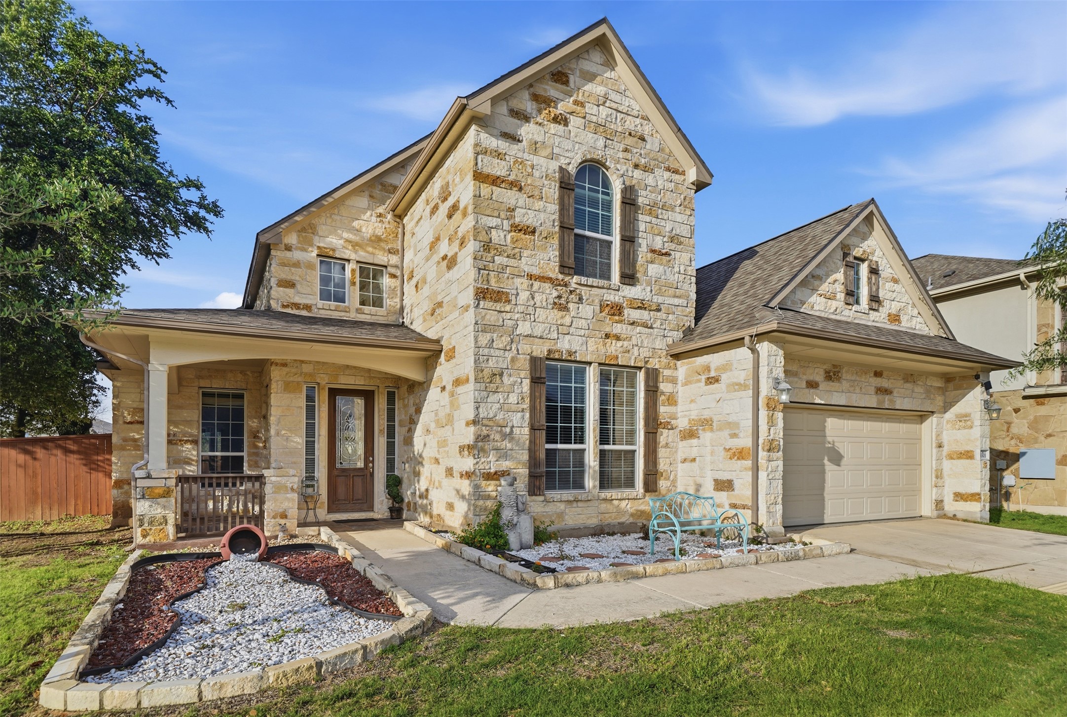 4301 Logan Ridge Drive Cedar Park, TX 78613 - Photo 3 of 38 French country inspired facade with stone siding, covered porch, concrete driveway, an attached garage, and roof with shingles