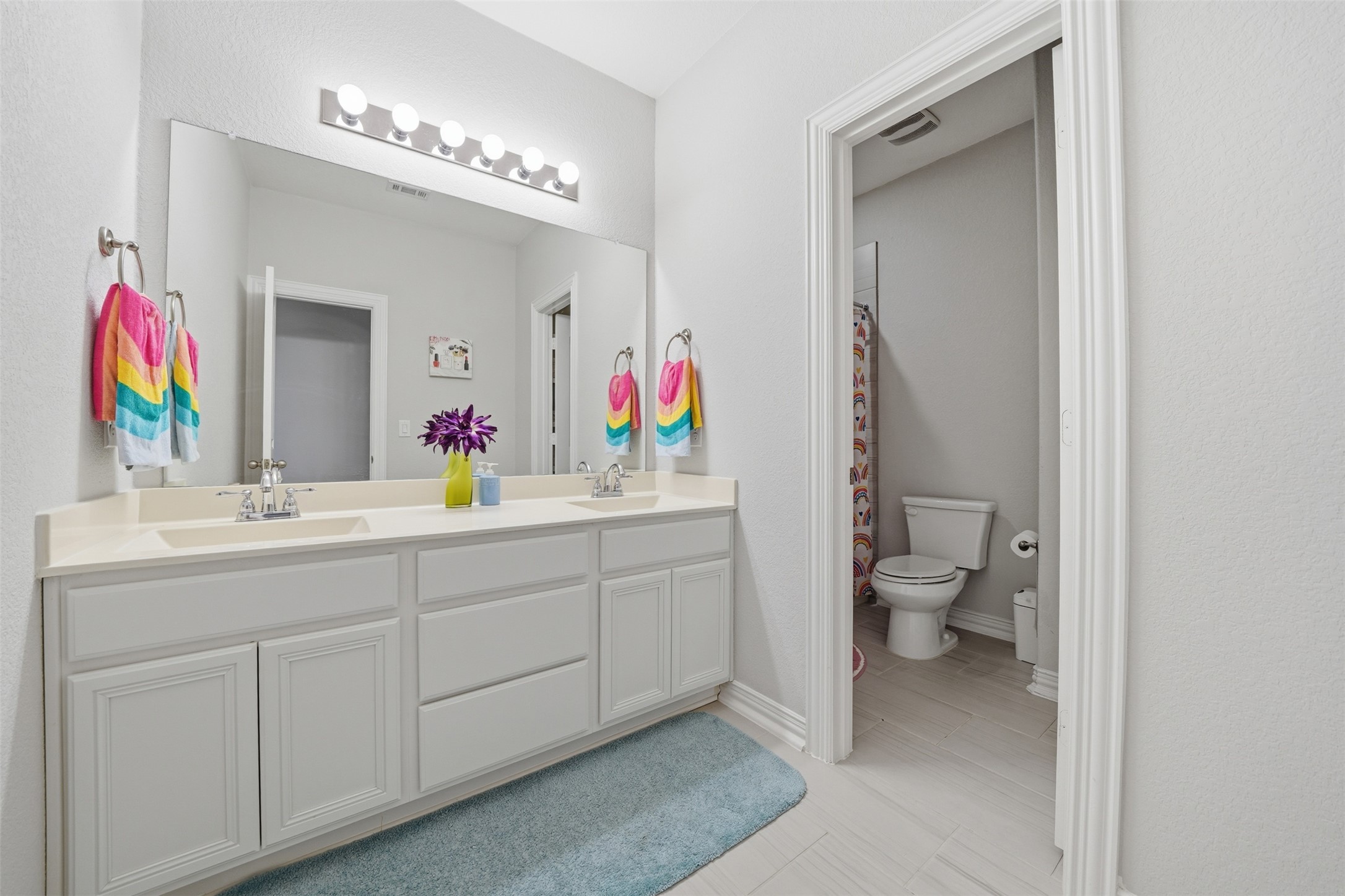 4301 Logan Ridge Drive Cedar Park, TX 78613 - Photo 30 of 38 Bathroom with double vanity and a shower with curtain