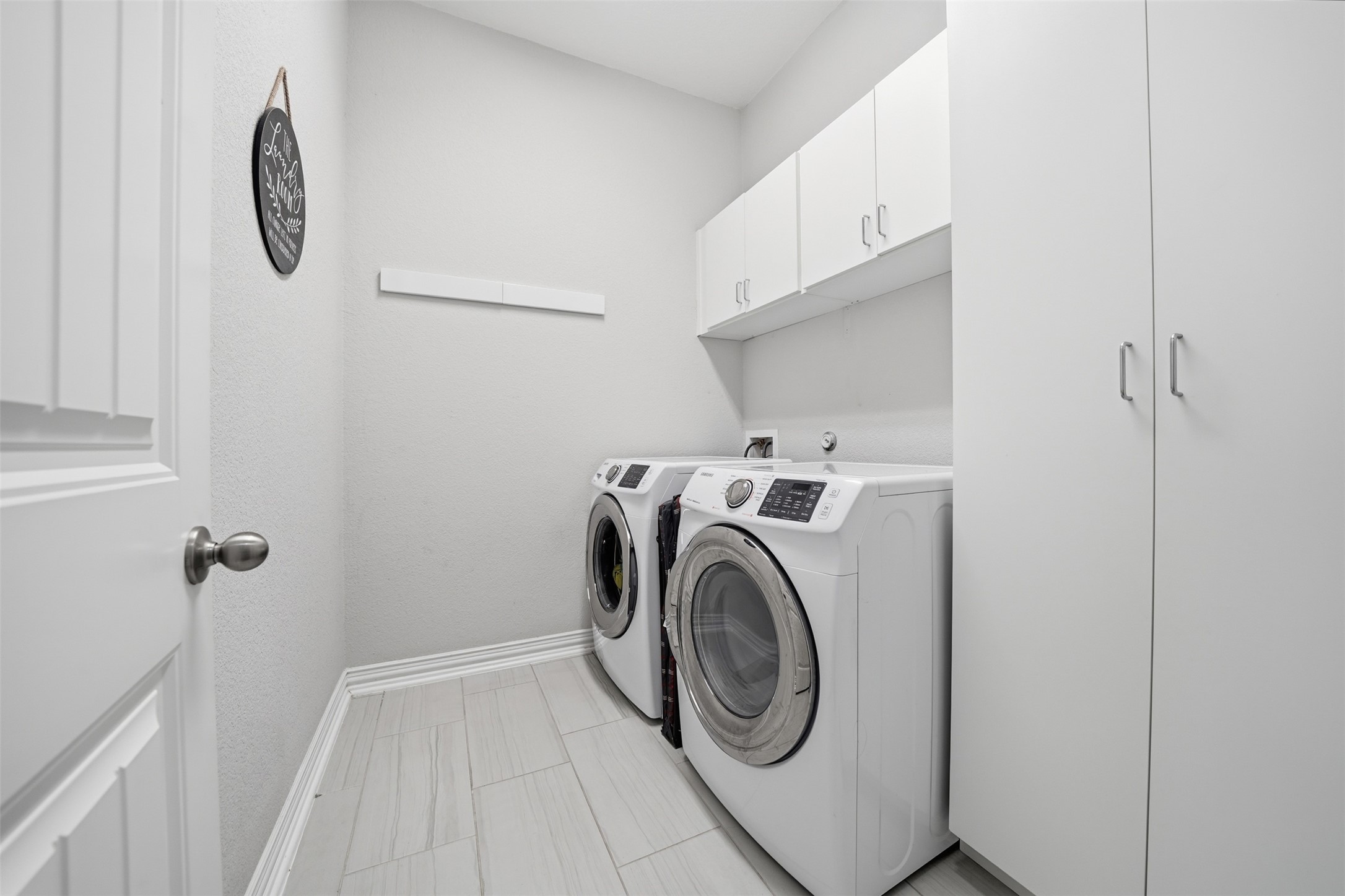 4301 Logan Ridge Drive Cedar Park, TX 78613 - Photo 32 of 38 Laundry area with cabinet space and washer and clothes dryer