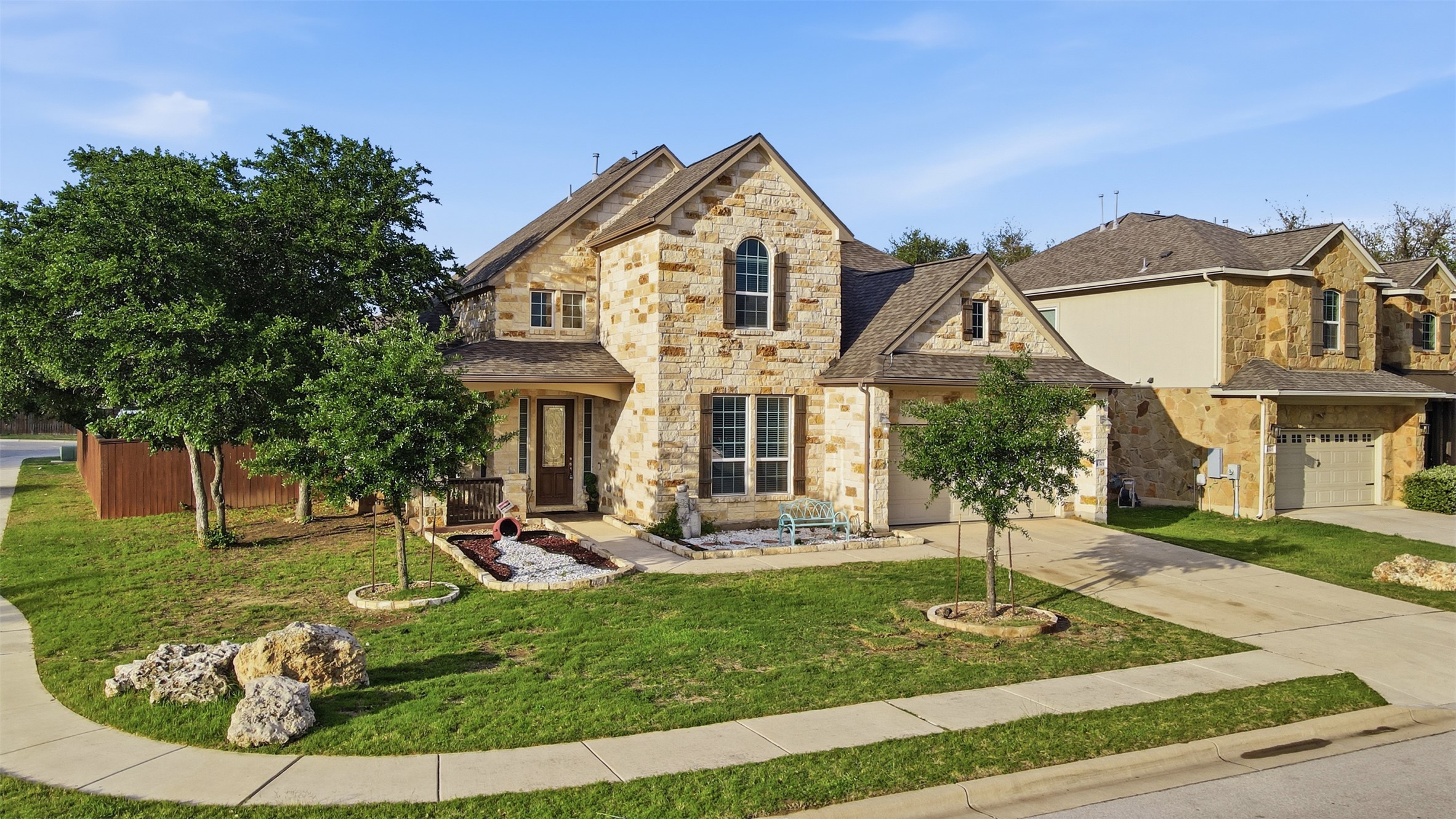 4301 Logan Ridge Drive Cedar Park, TX 78613 - Photo 6 of 38 View of front of house with stone siding, driveway, and a front yard