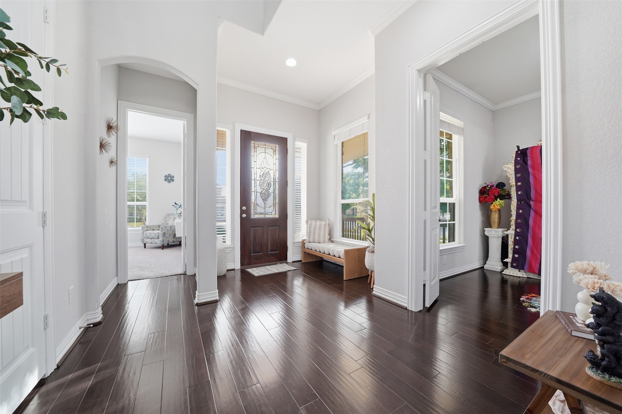 4301 Logan Ridge Drive Cedar Park, TX 78613 - Photo 8 of 38 Foyer with ornamental molding, arched walkways, and dark wood-style floors