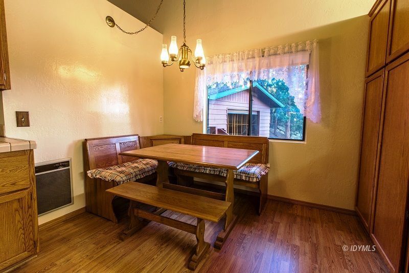 25020 Rim Rock Road Idyllwild, CA 92549 - Photo 16 of 34 a bedroom with a bed and wooden floor