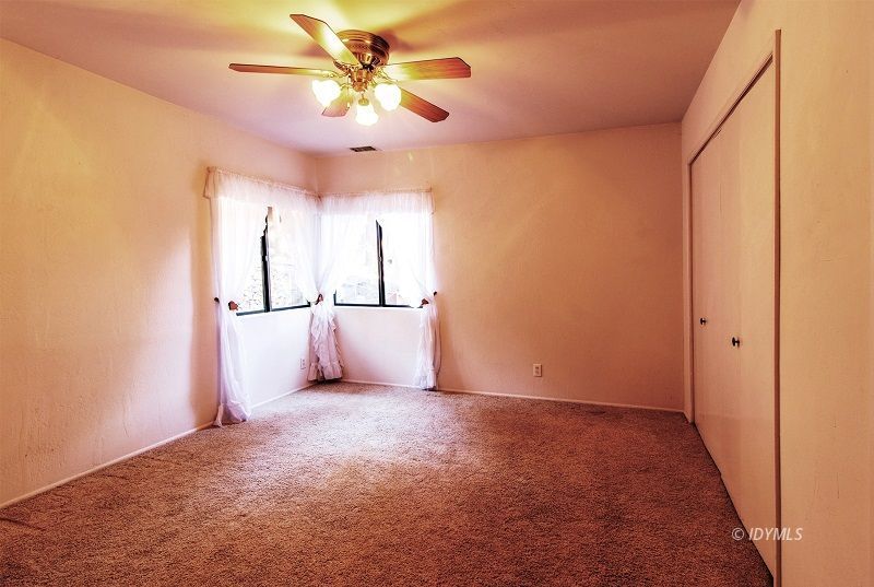 25020 Rim Rock Road Idyllwild, CA 92549 - Photo 19 of 34 a view of a big room with a ceiling fan and a chandelier fan