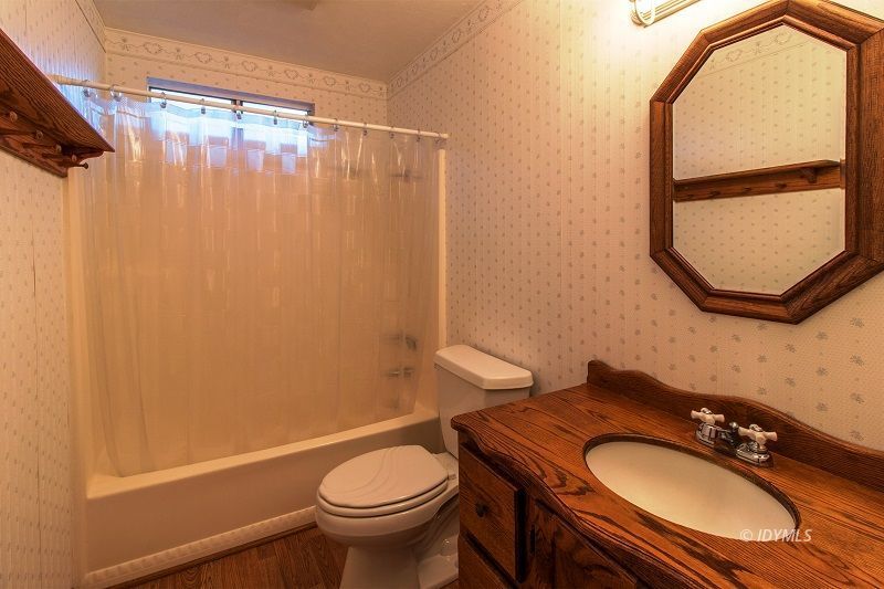 25020 Rim Rock Road Idyllwild, CA 92549 - Photo 21 of 34 a bathroom with a granite countertop sink toilet and a mirror