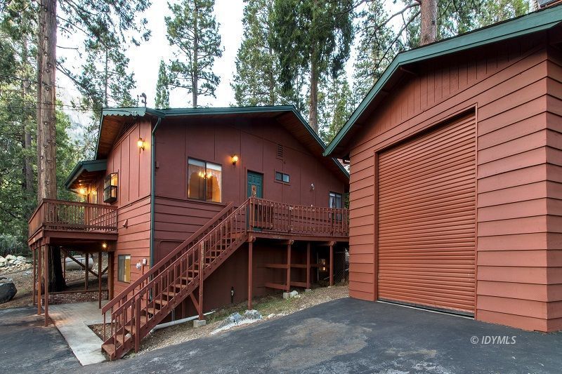 25020 Rim Rock Road Idyllwild, CA 92549 - Photo 3 of 34 a front view of a house with a tree