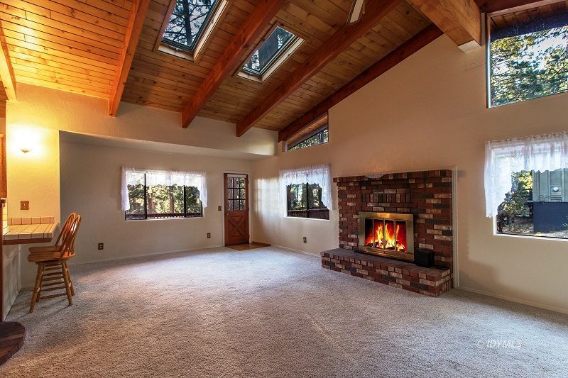 25020 Rim Rock Road Idyllwild, CA 92549 - Photo 9 of 34 a view of empty room with furniture and fireplace