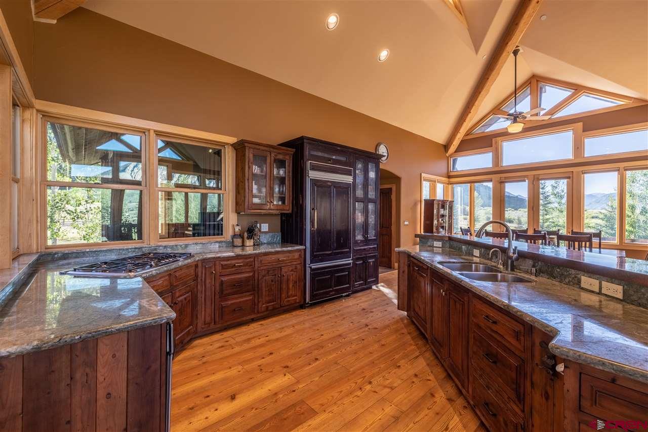 379 Smith Road Crested Butte, CO 81224 - Photo 13 of 35 a large kitchen with stainless steel appliances double vanity and a large window