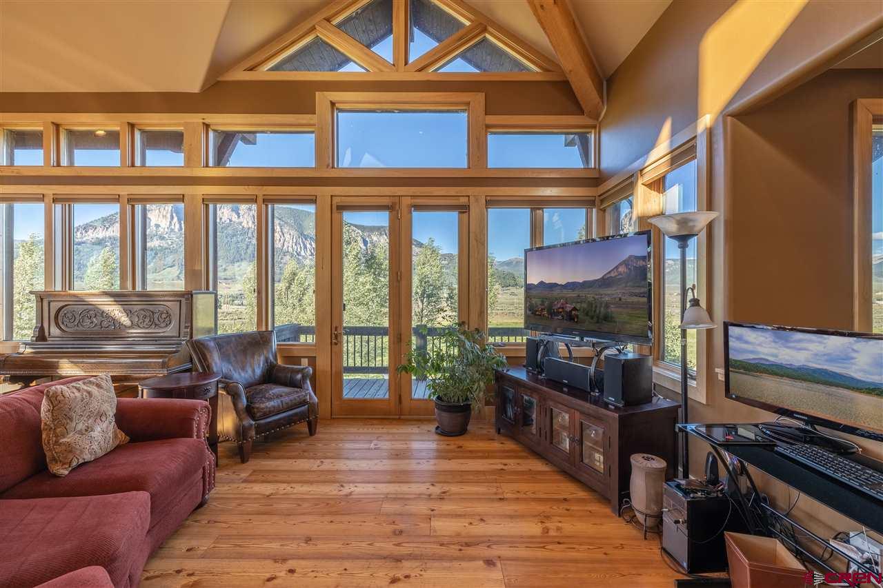 379 Smith Road Crested Butte, CO 81224 - Photo 14 of 35 a living room filled with furniture and a floor to ceiling window