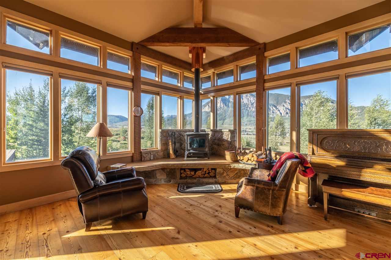 379 Smith Road Crested Butte, CO 81224 - Photo 15 of 35 a living room with furniture and a floor to ceiling window