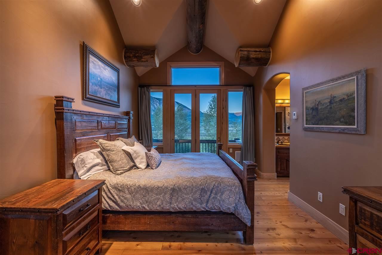 379 Smith Road Crested Butte, CO 81224 - Photo 18 of 35 a bedroom with a bed and a mirror on dresser