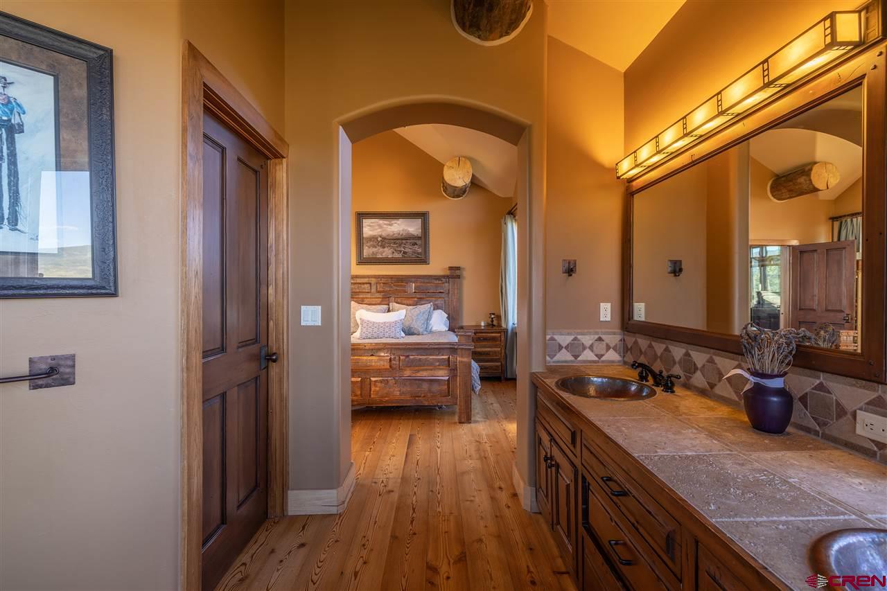 379 Smith Road Crested Butte, CO 81224 - Photo 21 of 35 a en suite bathroom with a granite countertop tub sink a mirror and shower
